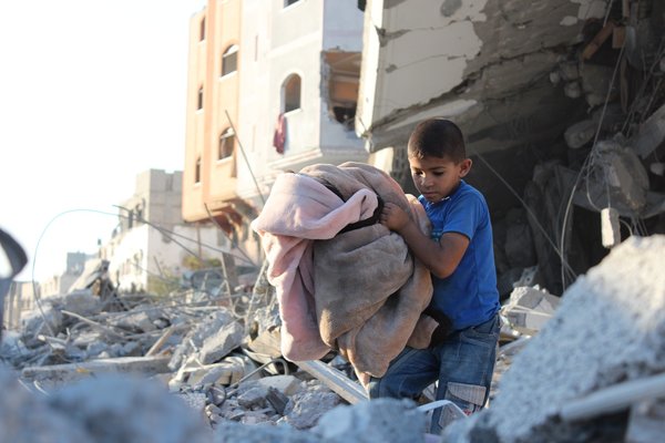 Child in the rubble of a building in Gaza